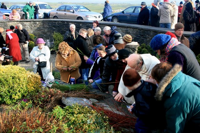 People making Brigid's crosses at St Brigid's Well