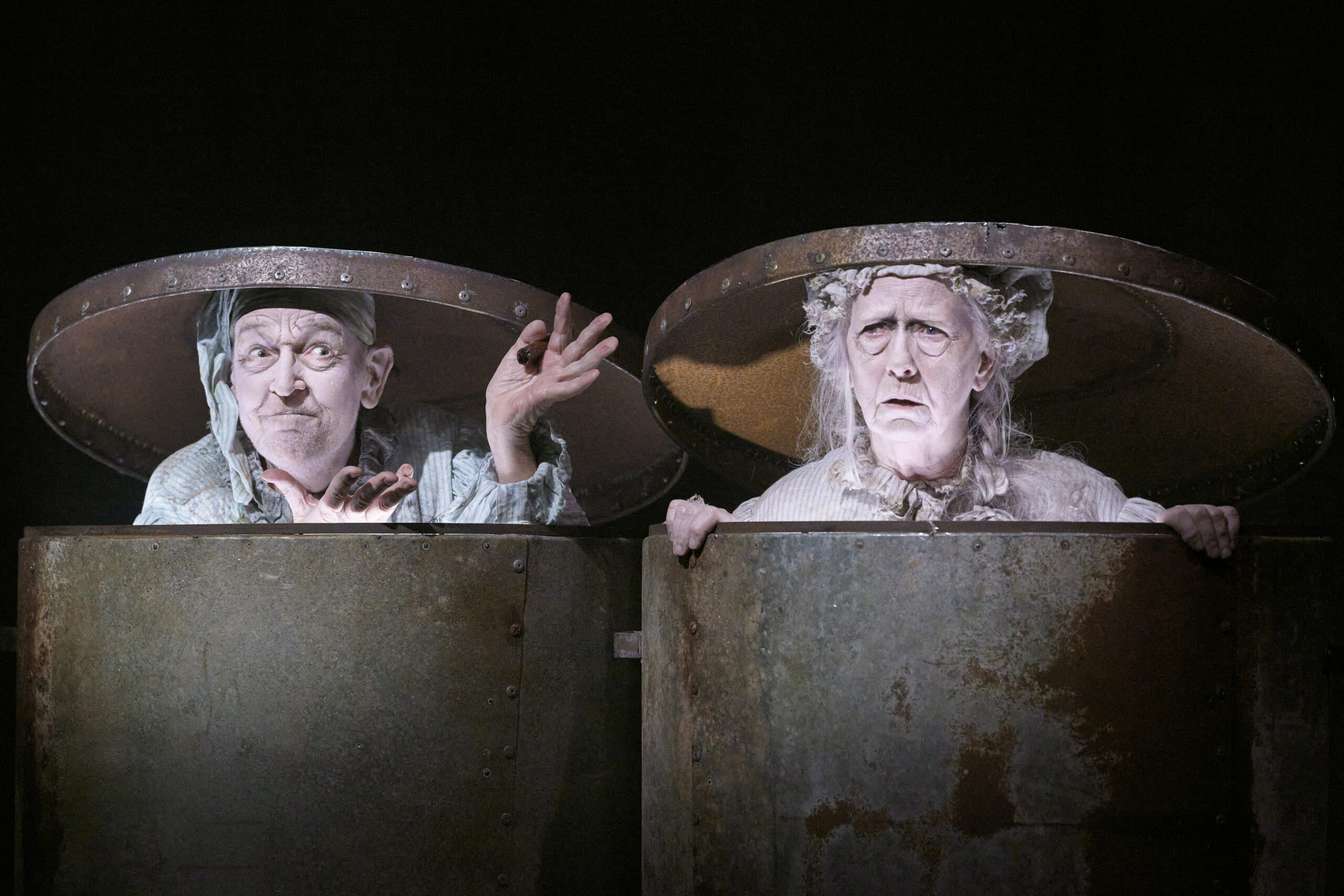 a man and a woman in garbage cans